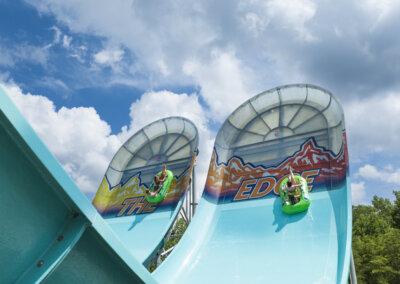 The Edge Watercoaster close up view of the wall with riders in tubes going up it for website gallery