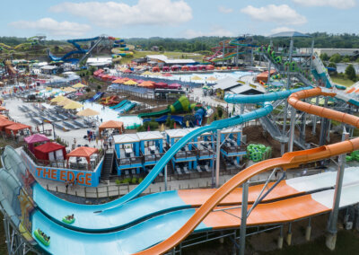 The Edge Watercoaster view of the park, ride and cabanas with riders in tubes going up the wall for website gallery